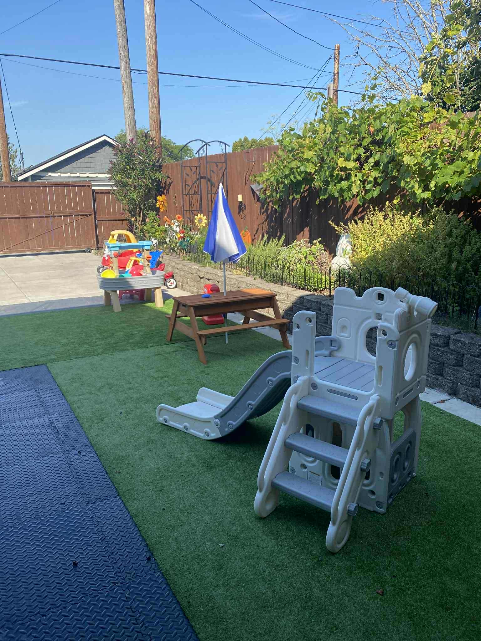 Outdoor play equipment with garden backdrop