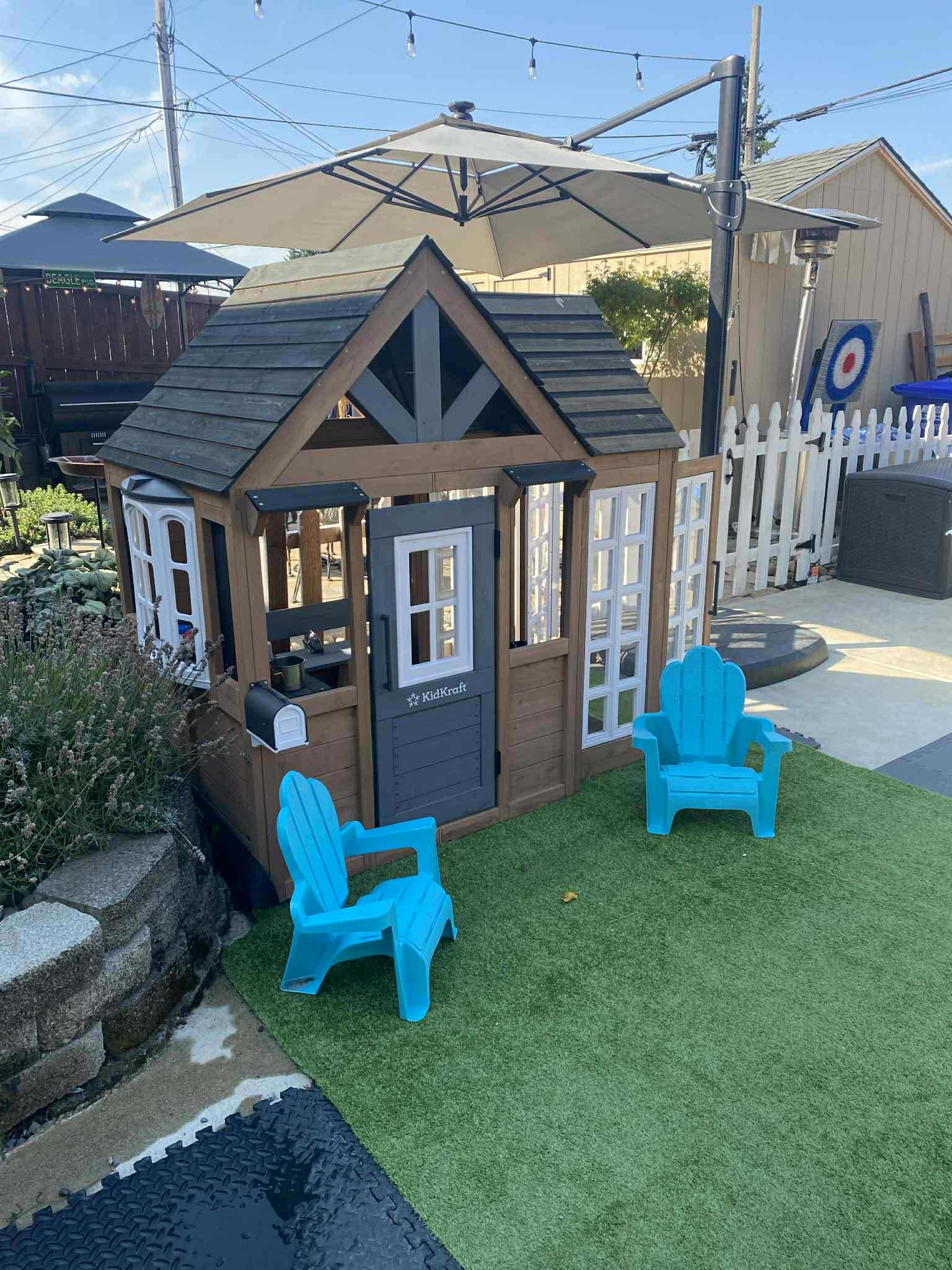 Charming outdoor playhouse with patio seating